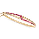 AN ANTIQUE RUBY AND DIAMOND BANGLE in yellow gold, the stylised bangle set with a row of round cu...