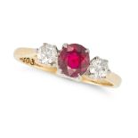 A RUBY AND DIAMOND THREE STONE RING in platinum, set with an oval cut ruby of approximately 0.81 ...