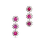 A PAIR OF RUBY AND DIAMOND CLUSTER DROP EARRINGS in 18ct white and yellow gold, each set with thr...
