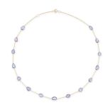 A SAPPHIRE CHAIN NECKLACE in 18ct yellow gold, the trace chain set with a row of fifteen fancy sh...