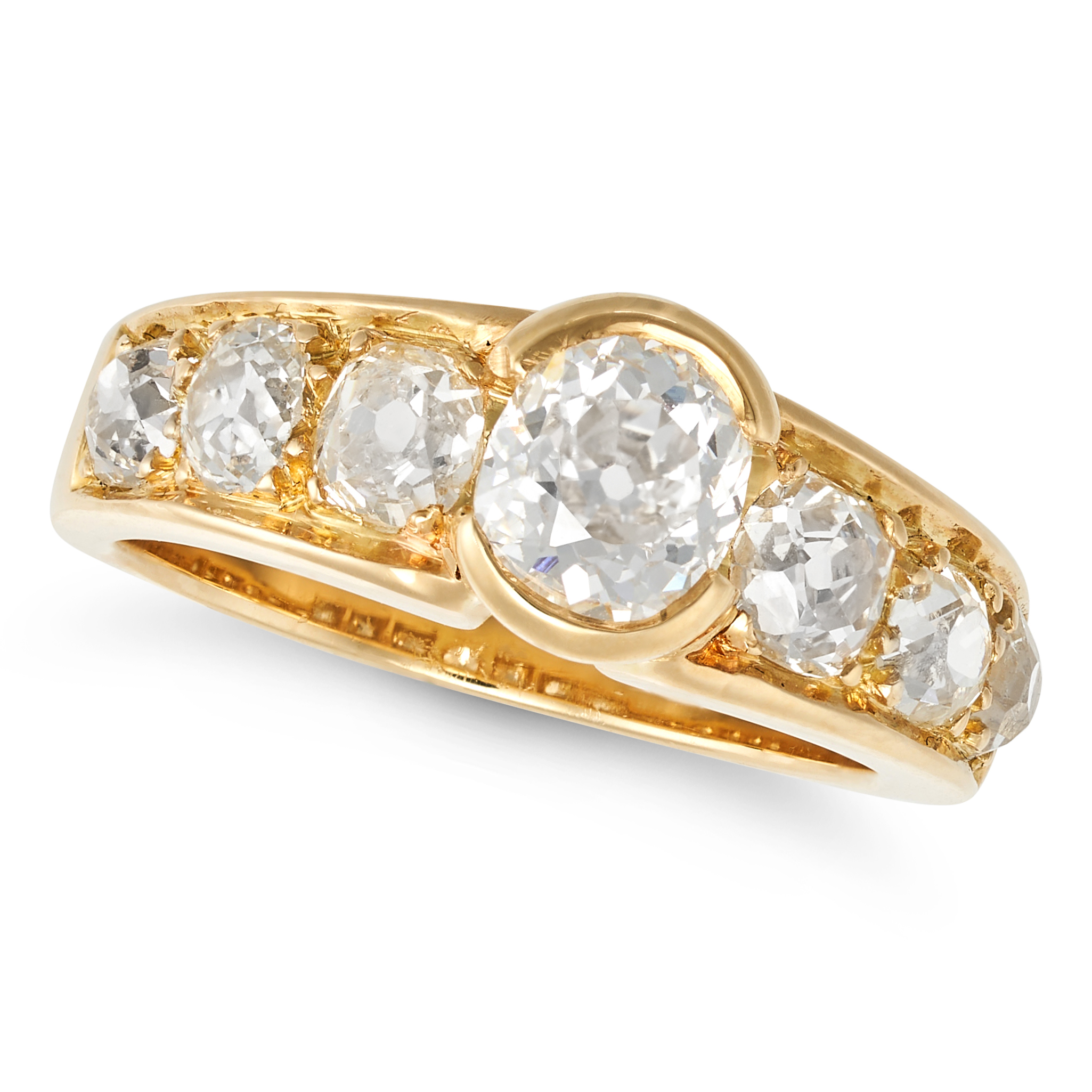 A DIAMOND SEVEN STONE RING in 18ct yellow gold, the tapering band set with seven old cut diamonds...