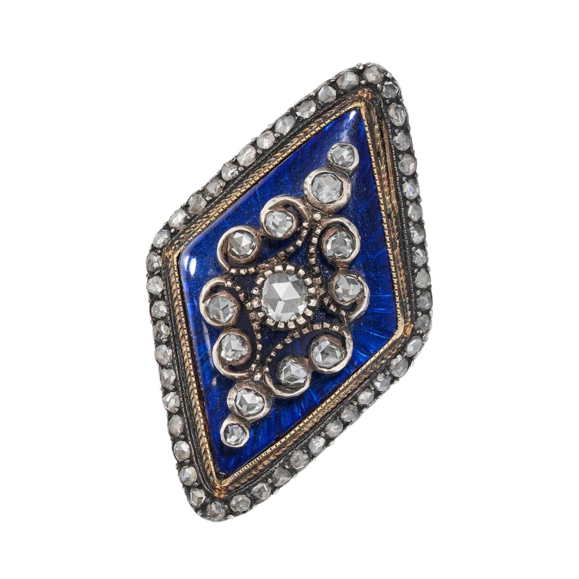 A DIAMOND AND BLUE GLASS DRESS RING in yellow gold and silver, the lozenge shaped face set a clus...