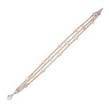 A MOONSTONE BRACELET in rose gold, comprising three rows of belcher chain accented by cabochon mo...