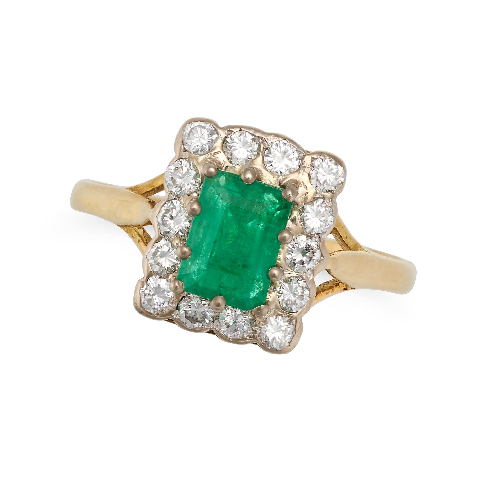 AN EMERALD AND DIAMOND CLUSTER RING in 18ct yellow gold, set with a rectangular step cut emerald ...