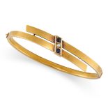 A VINTAGE SAPPHIRE AND DIAMOND BANGLE in 15ct yellow gold, the hinged body in crossover design, s...