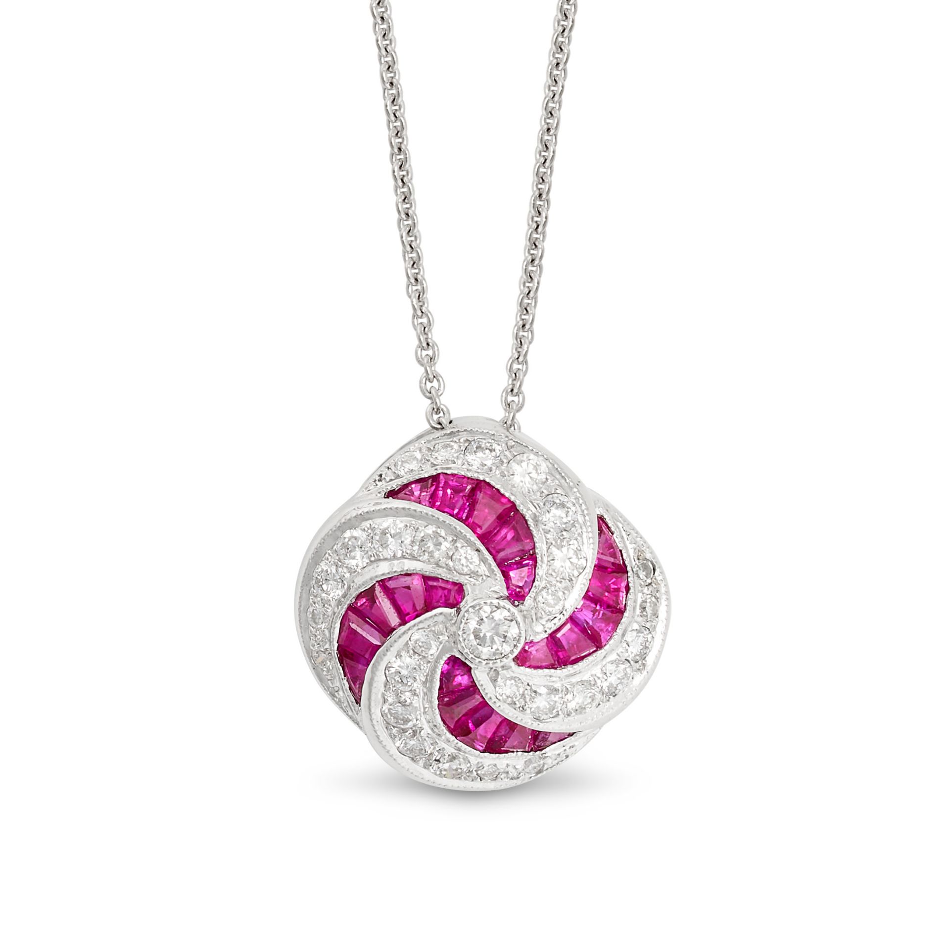 A RUBY AND DIAMOND PENDANT NECKLACE in 18ct white gold, the pendant in scrolling design, set with...