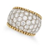 A DIAMOND DRESS RING in yellow and white gold, the tapering band pave throughout with round brill...