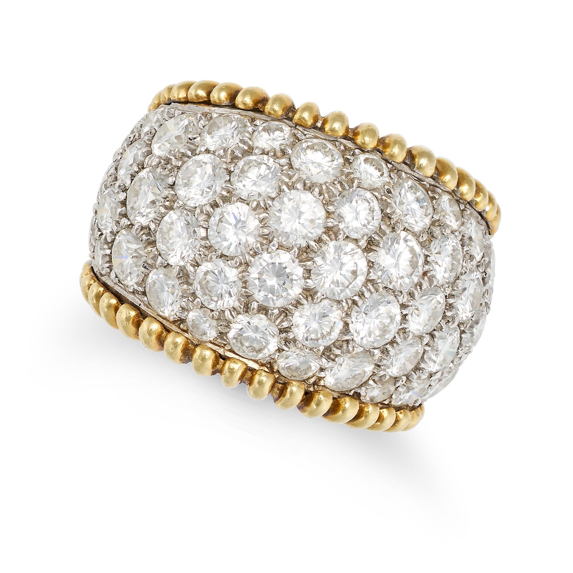 A DIAMOND DRESS RING in yellow and white gold, the tapering band pave throughout with round brill...