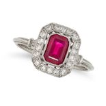 A RUBY AND DIAMOND CLUSTER RING in platinum, set with an octagonal step cut ruby in a border of r...