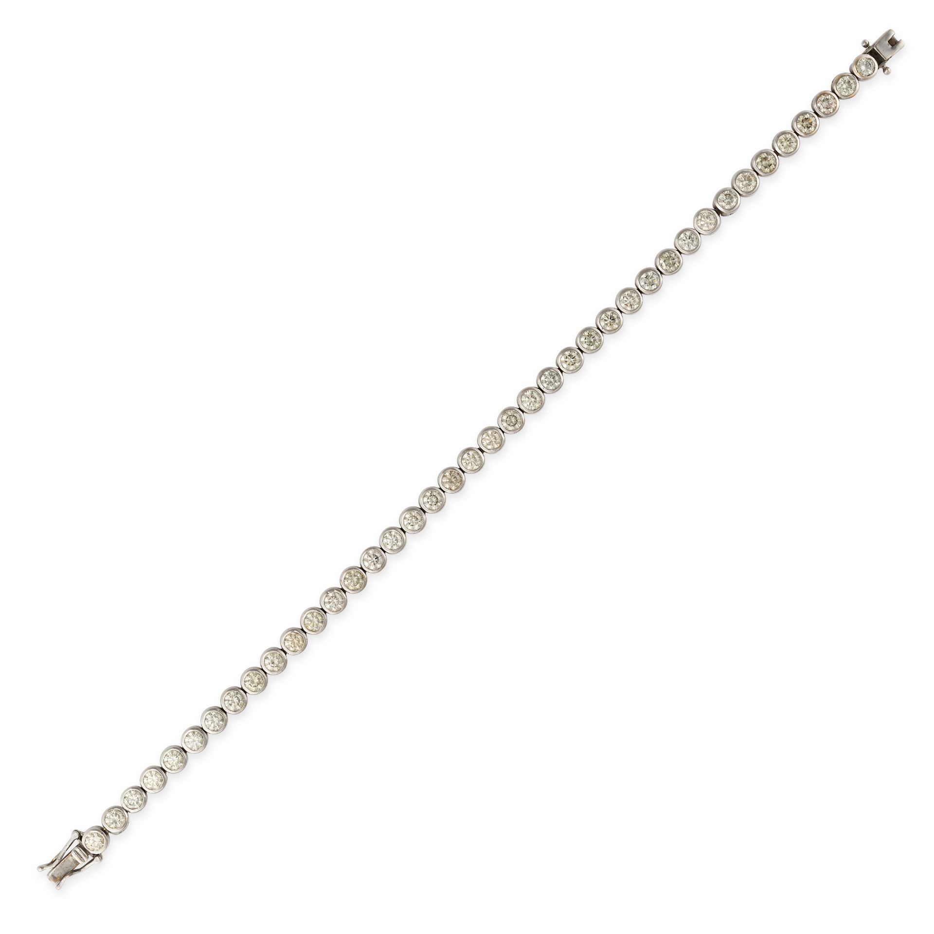 A DIAMOND LINE BRACELET in white gold, set with a row of round brilliant cut diamonds in bezel se...