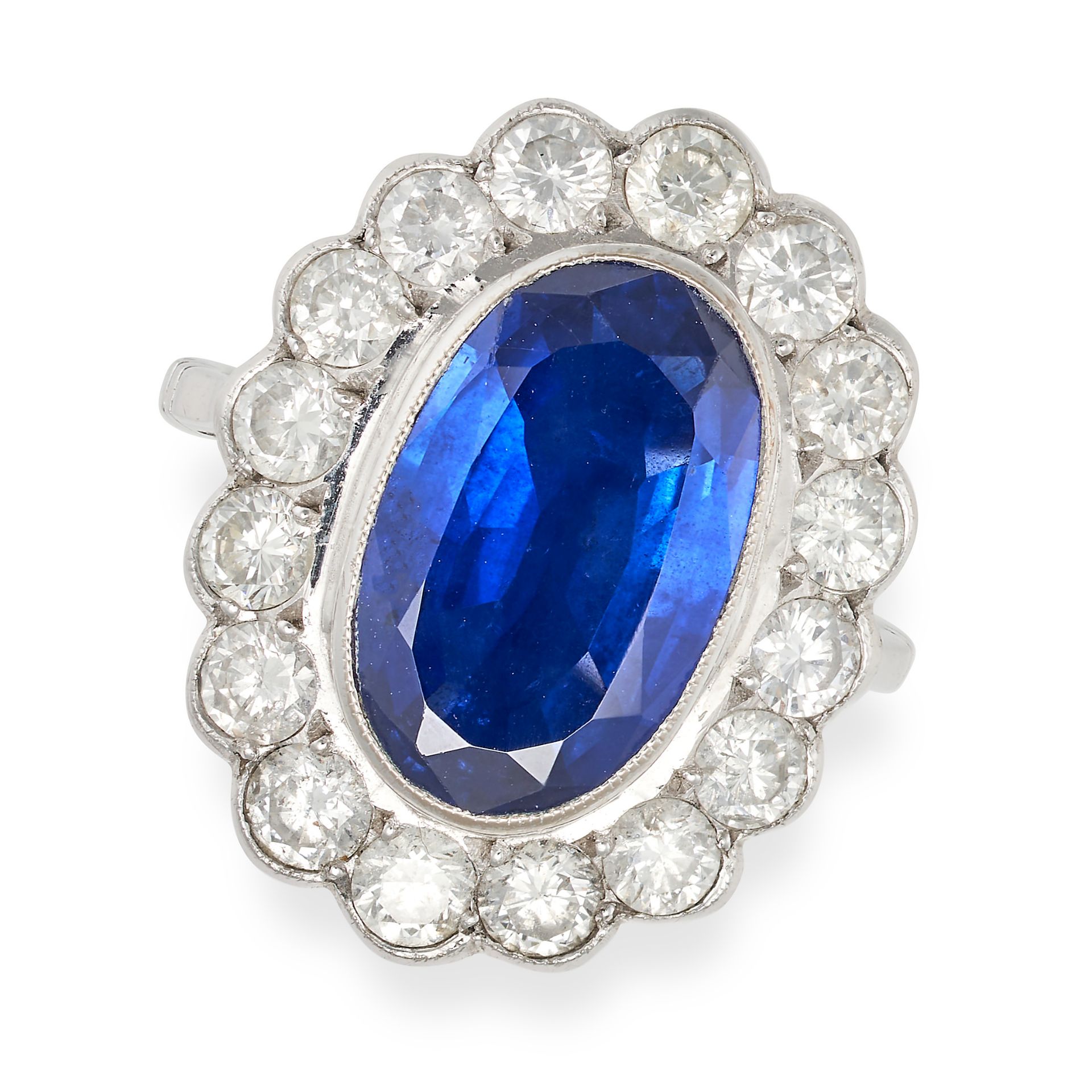 A SAPPHIRE AND DIAMOND CLUSTER RING in 18ct white gold, set with an oval cut sapphire of approxim...