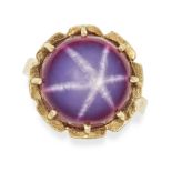 A SYNTHETIC STAR RUBY RING in yellow gold, set with a round cabochon synthetic star sapphire of a...