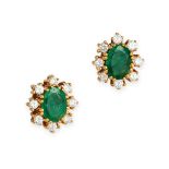 A PAIR OF EMERALD AND DIAMOND CLUSTER EARRINGS in yellow gold, each set with an oval cut emerald ...