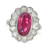 A RUBY AND DIAMOND CLUSTER RING in 18ct white gold, set with an oval cut ruby of approximately 6....