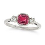 A PINK SAPPHIRE AND DIAMOND THREE STONE RING in platinum, set with an octagonal step cut pink sap...