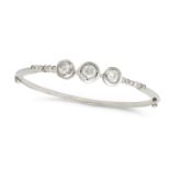 A DIAMOND BANGLE set with three principal old cut diamonds of approximately 0.53, 0.66 and 0.47 c...