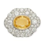 A YELLOW SAPPHIRE AND DIAMOND BROOCH in white gold, set with an oval cut yellow sapphire of appro...