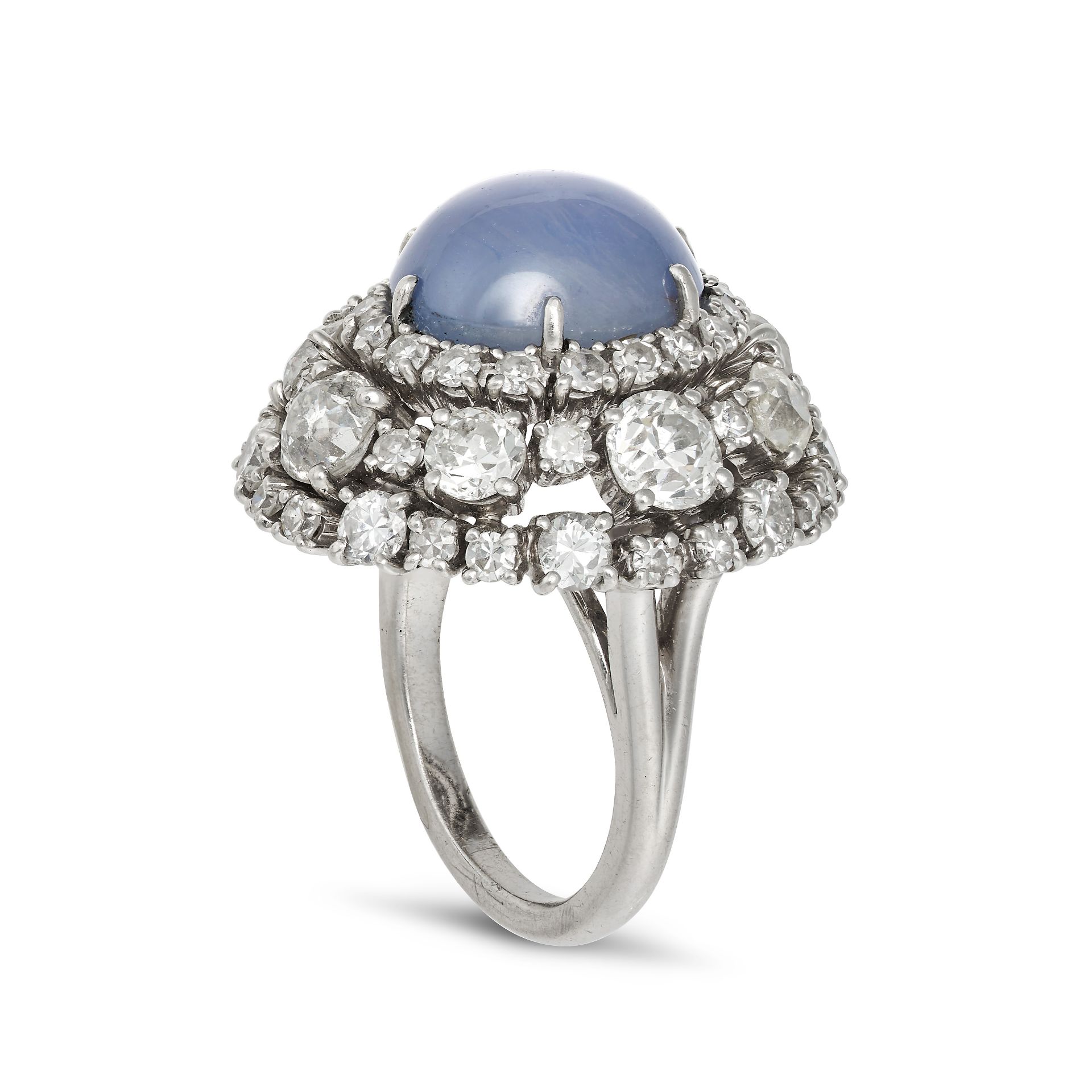 A STAR SAPPHIRE AND DIAMOND DRESS RING in platinum, set with an oval cabochon star sapphire of ap... - Image 2 of 2