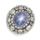 A STAR SAPPHIRE AND DIAMOND DRESS RING in platinum, set with an oval cabochon star sapphire of ap...