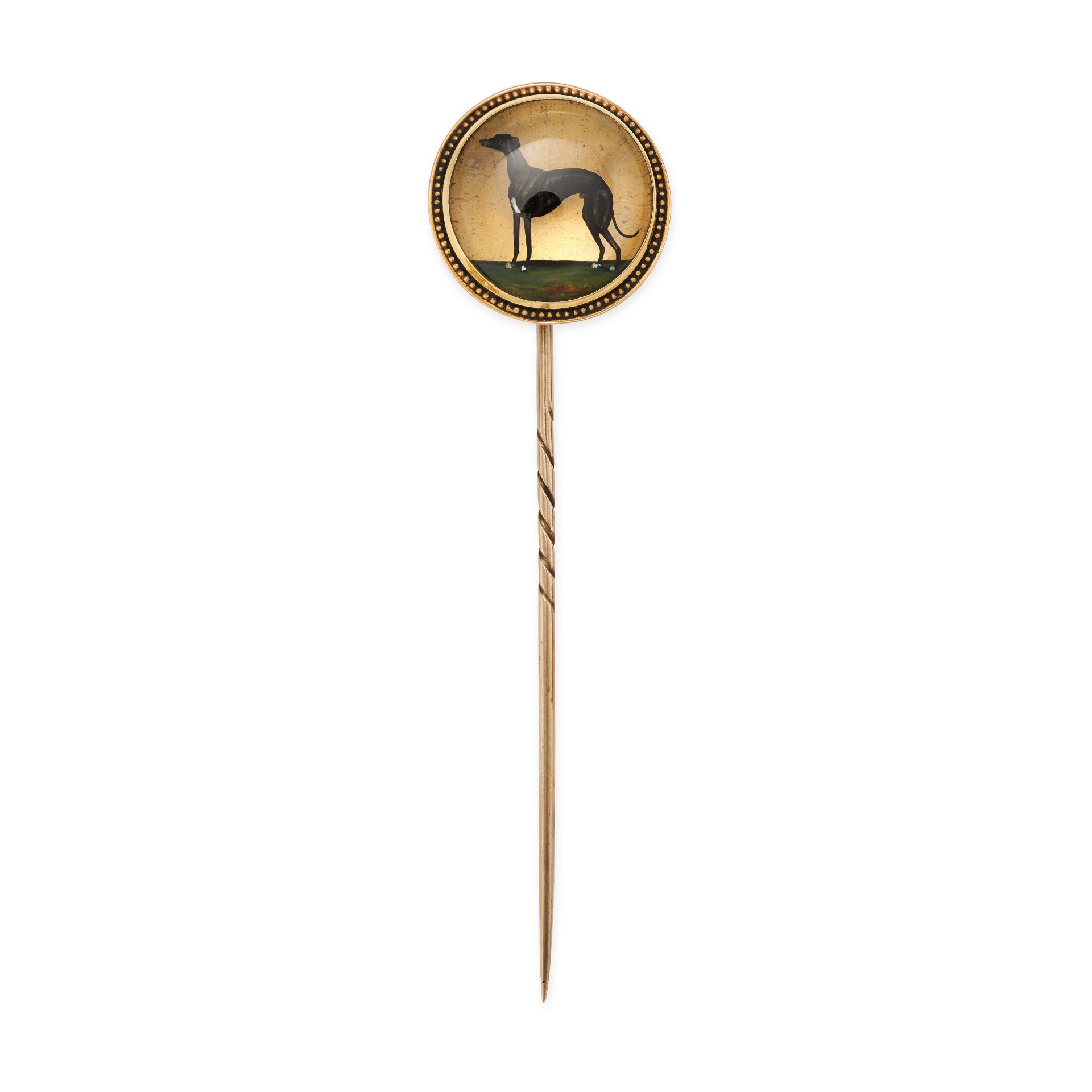 AN ANTIQUE ESSEX CRYSTAL REVERSE INTAGLIO GREYHOUND STICK PIN in yellow gold, set with a round re...