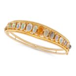 AN ANTIQUE OPAL BANGLE in 15ct yellow gold, the hinged bangle set with a row of oval cabochon opa...