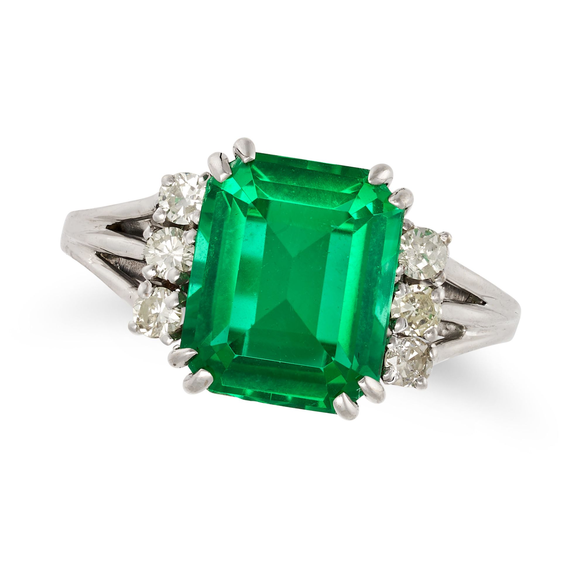 A SYNTHETIC EMERALD AND DIAMOND RING in white gold, set with an octagonal step cut synthetic emer...