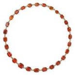 AN ANTIQUE HESSONITE GARNET RIVIERE NECKLACE in yellow gold, set with a row of graduated cushion ...