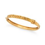 AN ANTIQUE GOLD BELT BANGLE in 9ct yellow gold, the hinged bangle designed as a belt, engraved wi...