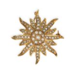 A PEARL STAR BROOCH / PENDANT in 14ct yellow gold, designed as a sixteen rayed star, set to the c...