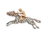 A VINTAGE DIAMOND HORSE AND JOCKEY BROOCH in yellow gold and silver, designed as a horse being ri...