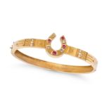 AN ANTIQUE RUBY, DIAMOND AND PEARL HORSESHOE BANGLE in 15ct yellow gold, the horseshoe set with a...