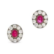 A PAIR OF RUBY AND DIAMOND EARRINGS in yellow gold and silver, each set with an oval cabochon rub...