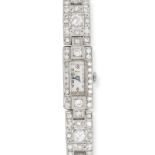 A FINE ART DECO DIAMOND COCKTAIL WATCH in platinum, the rectangular case set with a border of old...
