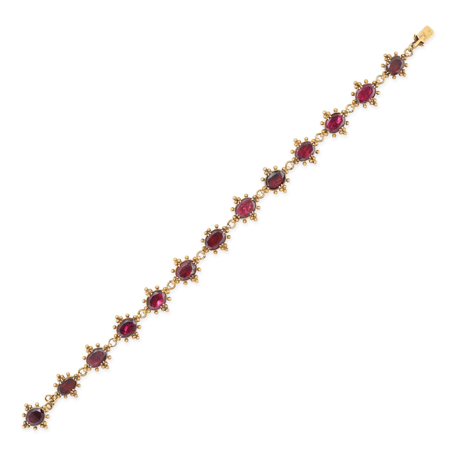 A GARNET BRACELET in yellow gold, comprising a row of oval cut garnets within beaded borders, no ...