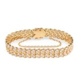 A DIAMOND BRACELET in 18ct yellow gold, comprising two rows of round brilliant cut diamonds, the ...