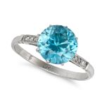 A BLUE ZIRCON AND DIAMOND RING in platinum, set with a round cut blue zircon, the shoulders accen...