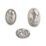 THREE UNMOUNTED SILVER INTAGLIOS depicting Cupid riding a lion, the goddess Diana, and Hercules w...