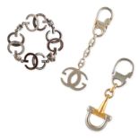 NO RESERVE - GUCCI, AN ENAMEL BRACELET AND TWO KEYRINGS the bracelet comprising a row of GG motif...