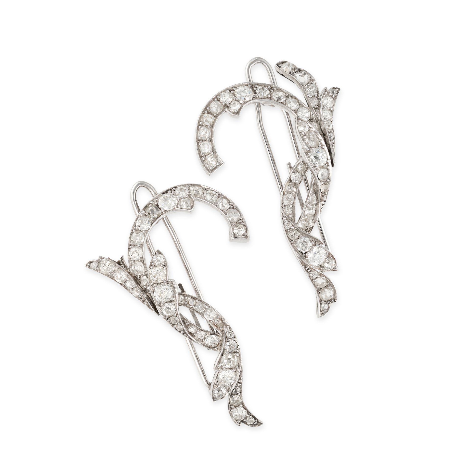 A SET OF DIAMOND HAIR CLIPS in white gold, each hair clip in a scrolling design set with old cut ...