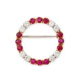 A RUBY AND DIAMOND BROOCH in 18ct yellow and white gold, designed as an open circle set with alte...