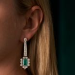 A PAIR OF FINE COLOMBIAN EMERALD AND DIAMOND DROP EARRINGS in platinum, each comprising a row of ...