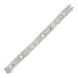 A DIAMOND BRACELET in 18ct white gold, comprising a series of openwork panels set throughout with...