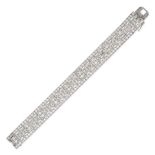 A FRENCH DIAMOND BRACELET in platinum, the openwork bracelet set throughout with old and single c...