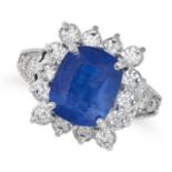 A SAPPHIRE AND DIAMOND CLUSTER RING in 18ct white gold, set with a cushion cut sapphire of approx...