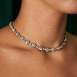 AN EXQUISITE FRENCH DIAMOND RIVIERE NECKLACE / PAIR OF BRACELETS in 18ct white gold, set with a r...