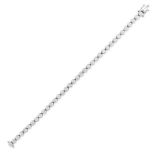 A DIAMOND LINE BRACELET in 18ct white gold, comprising a row of round brilliant cut diamonds, the...