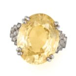 A FINE CEYLON NO HEAT YELLOW SAPPHIRE AND DIAMOND RING in platinum, set with an oval cut yellow s...