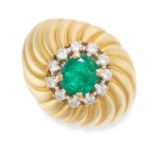 NO RESERVE - A VINTAGE EMERALD AND DIAMOND BOMBE RING in yellow gold, set with an oval cut emeral...