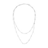 A DIAMOND CHAIN NECKLACE in platinum, the trace chain set with alternating round brilliant cut di...