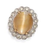 A CATS'S EYE CHRYSOBERYL AND DIAMOND CLUSTER RING in 18ct yellow gold, set with an oval cabochon ...